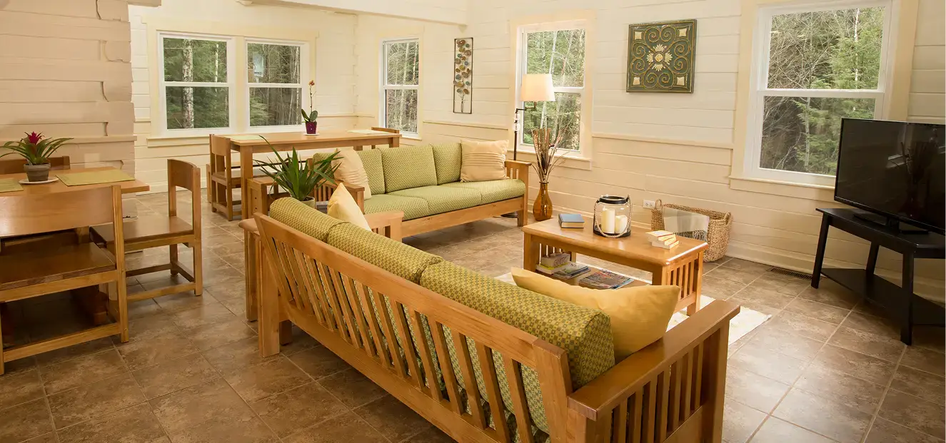 Green Mountain Treatment Center furnished common room with couches, coffee table, TV