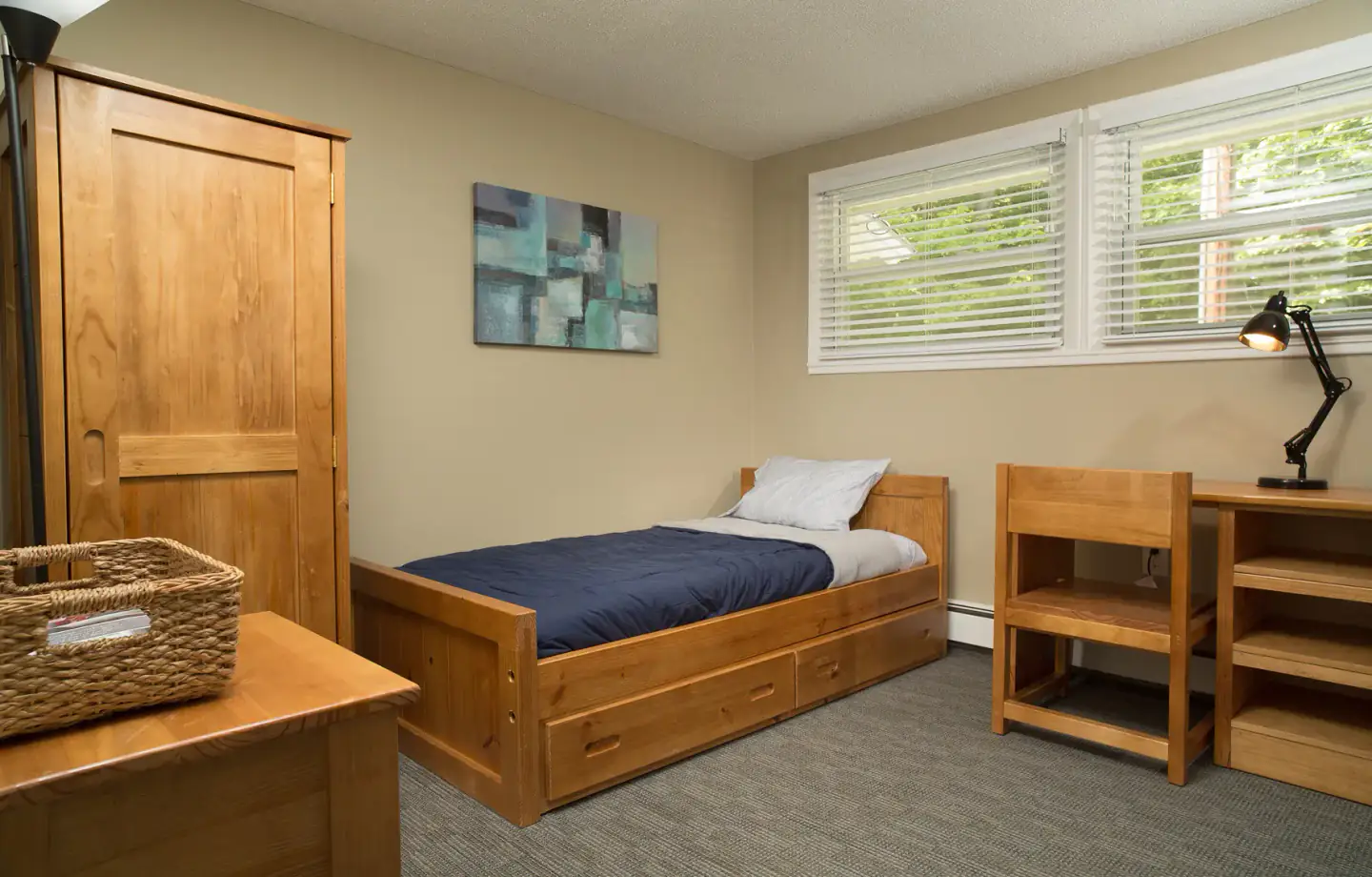 Private recovery bedroom at New Freedom Academy with single wooden bed