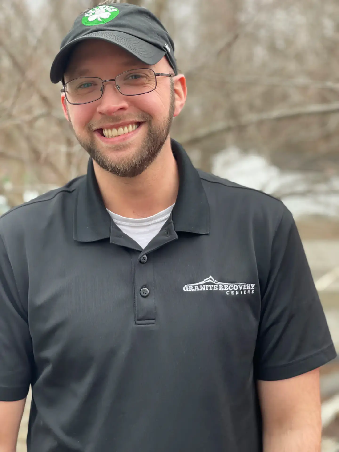 Smiling Granite Recovery Centers staff member in branded polo