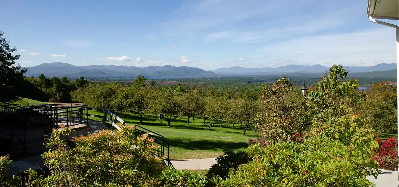 Green Mountain Treatment Center grounds overlooking mountain range and orchard