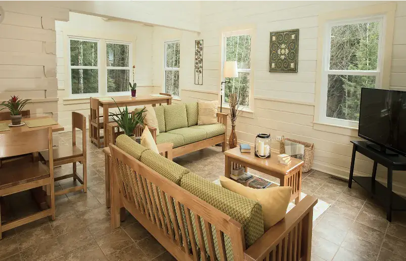 Green Mountain Treatment Center communal living room with sofas, dining table, and TV